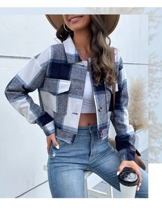 Detail shot of blue and white checkered cropped jacket with large chest flap pockets