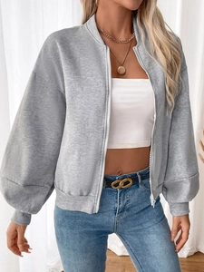 Detail of grey zip-up fleece sweatshirt showing ribbed cuffs and drop shoulder texture