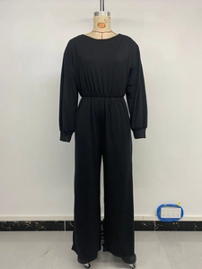 Front view of black long sleeve jumpsuit featuring elastic waist and wide leg on mannequin