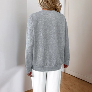 Light gray long sleeve crewneck sweatshirt with a loose fit and a casual style