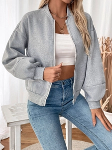 Detail of grey zip-up sweatshirt with ribbed cuffs and white zipper on a model