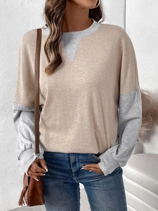 Detail of color-block crewneck sweatshirt with beige body and grey long sleeves on model
