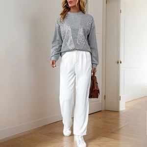Grey long sleeve sweatshirt with V-shaped sequins paired with white wide-leg trousers