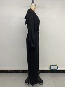 Side view of black long sleeve hooded jumpsuit with high waist and ribbed cuffs