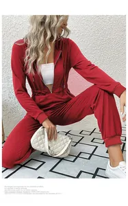 Detail view of the red long sleeve hooded jumpsuit with zipper and elastic waist