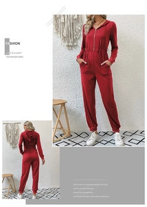 Detail of red hooded jumpsuit with front zipper, elastic waist and ribbed ankle cuffs