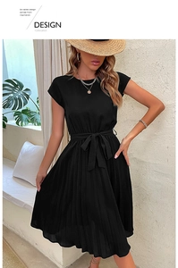 Detail of black pleated mid-length dress featuring a round neck and waist tie belt