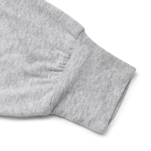 Close-up of grey marl knit sweater with elastic ribbed cuffs and detailed stitching