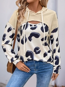 Detail of beige cropped hoodie layered over a leopard print long sleeve top set
