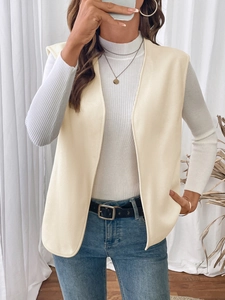 Close-up of beige fleece vest with open front design and textured fabric for women