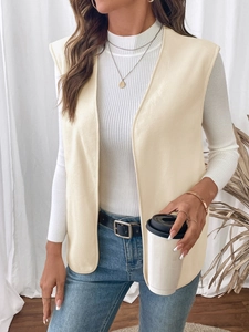 Detail of soft cream fleece vest texture and long sleeveless design on model