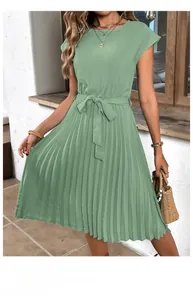 Detail of mint green sleeveless pleated dress with a high waist tie design