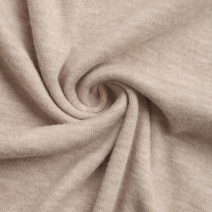 Close-up of soft beige knitted fabric texture with premium stitch detail for women's tops