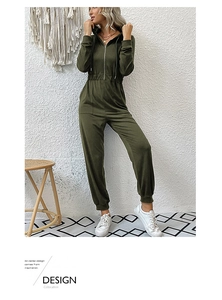 Detail of olive green hooded jumpsuit with front zipper and elastic waist cinching