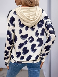 Detail view of women's leopard print hoodie with cream hood and relaxed fit on back