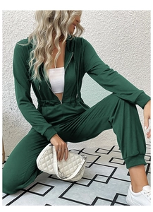 Detail of dark green hooded long sleeve jumpsuit with zipper closure and cinched waist
