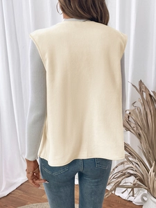 Back view of a cream fleece vest for women paired with casual long-sleeve top