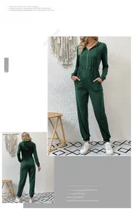 Detail of dark green hooded jumpsuit featuring front zipper closure and elastic waist