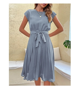 Detail of the high waist tie and pleated skirt texture on a blue summer dress