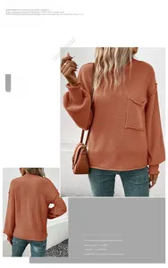 Detail of orange knitted sweater with ribbed cuffs and decorative front pocket