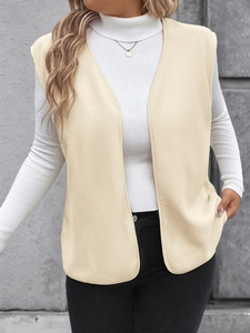 Detail shot of the cream beige sleeveless polar fleece vest with its soft premium texture