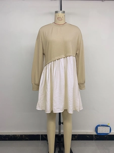 Detail of long sleeve dress featuring khaki bodice and irregular pleated white hem