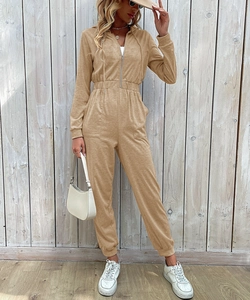 Detail of khaki hooded jumpsuit featuring a front metal zipper and elastic waist design