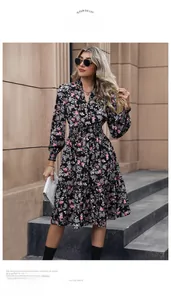 Detail of floral V-neck dress with elastic waist and ruffled hem in black floral print