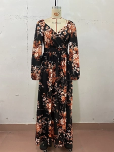 Detailed close-up of a floral V-neck maxi dress with long sleeves and elastic cuffs