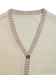 Detail of V-neck knit vest with beige stripes, ribbed edges and tortoise shell button
