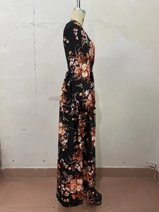 Detail of floral printed maxi dress with long sleeves and elastic waist on mannequin
