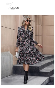 Detail of V-neck floral dress with waist pleats and tiered hem in street setting