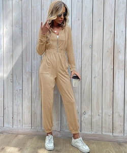 Detail view of khaki hooded jumpsuit with front zipper and elastic waist and cuffs