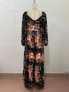 Detail of floral printed long sleeve dress featuring deep V-back and high waist cut