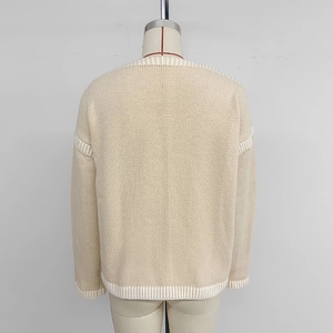 Back view of beige knit cardigan with contrast white ribbing and V-neckline detail