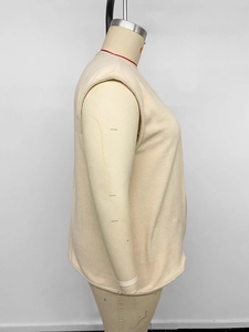 Side view of beige polar fleece vest on mannequin showing soft texture and relaxed fit