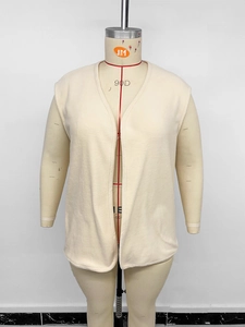 Close-up of cream polar fleece vest with plush texture and sleeveless open-front design