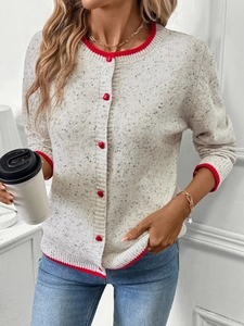 Detail of oatmeal knit cardigan with red heart buttons and contrasting ribbed edges