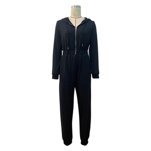 Detail of hooded black jumpsuit with metal zipper, drawstring and elastic waist
