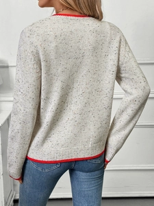 Back view of beige speckled knit cardigan with contrast red ribbed collar and cuffs
