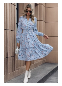 Detail of light blue floral dress with smocked waist and delicate ruffles