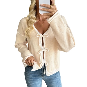 Chic beige V-neck knit cardigan with stylish bow-tie closures and soft ribbed texture