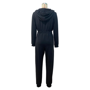 Rear view of black hooded jumpsuit showing elastic waist and comfortable knit fabric texture