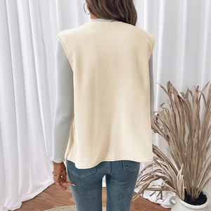 Back view of a cozy cream fleece vest worn over a grey long-sleeve top for casual layering
