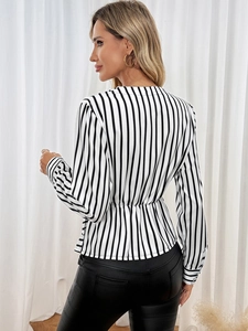 Detail of waist design on black and white striped peplum shirt with elastic waist