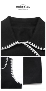 Détail du gilet en laine noire avec broderie zigzag blanche sur le col et les bords