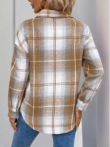 Detail view showing the back of an oversized brown plaid flannel shirt with drop shoulders