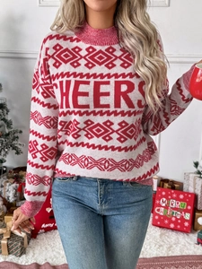 Close-up of CHEERS lettering on Christmas knit sweater with festive pattern and rib cuffs