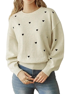Women's cream knit sweater with black heart pattern and casual crewneck design