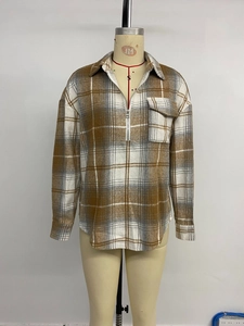 Detailed view of women's vintage plaid shirt with half-zip collar and front chest pocket